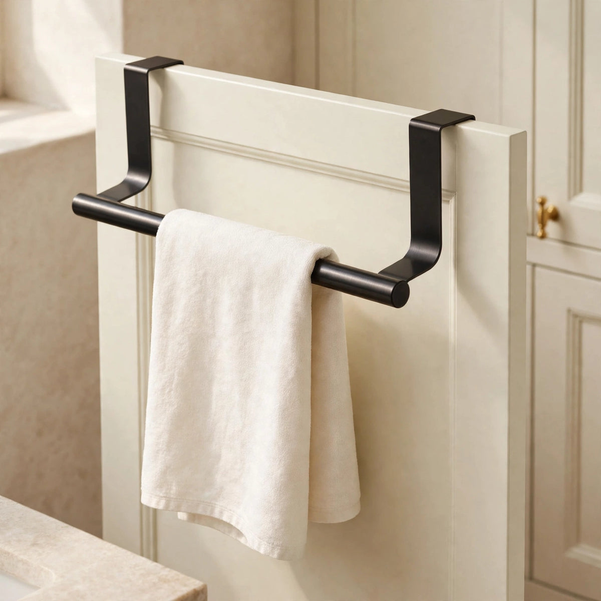 Towel bar over a cabinet door with ivory towel