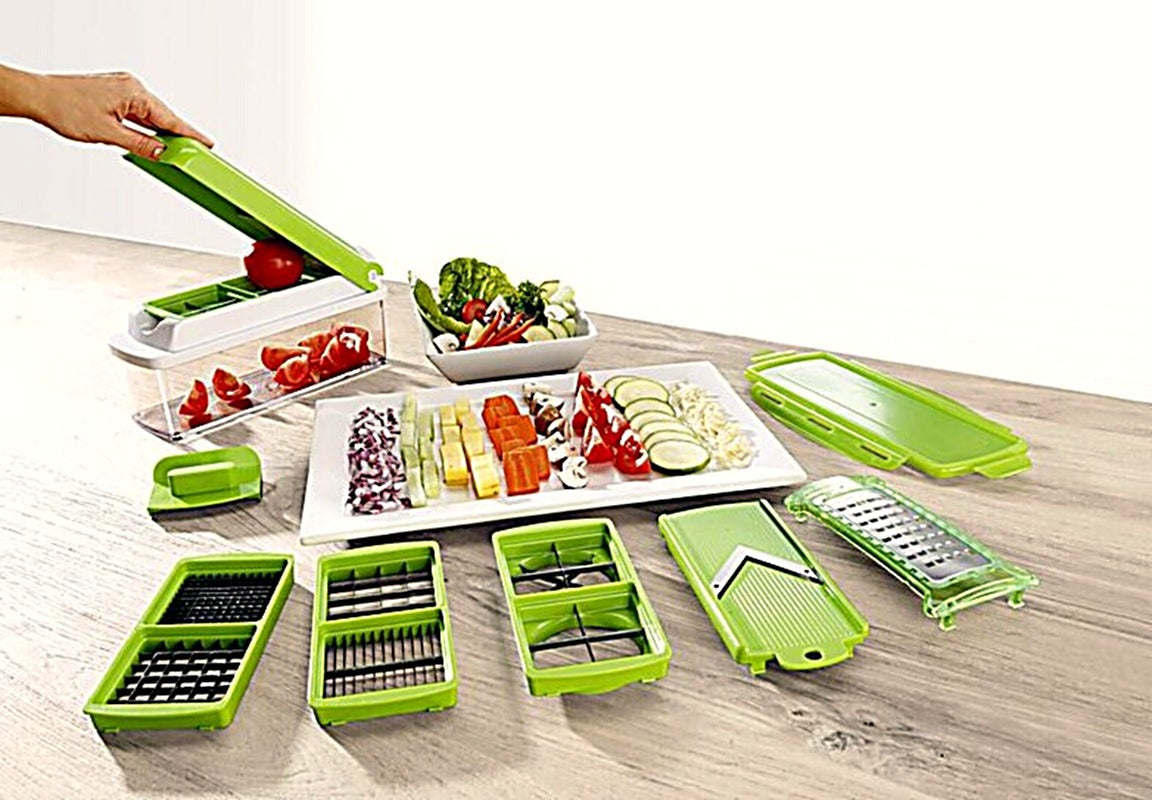 QuickChop pressing a tomato with blade inserts and chopped vegetables